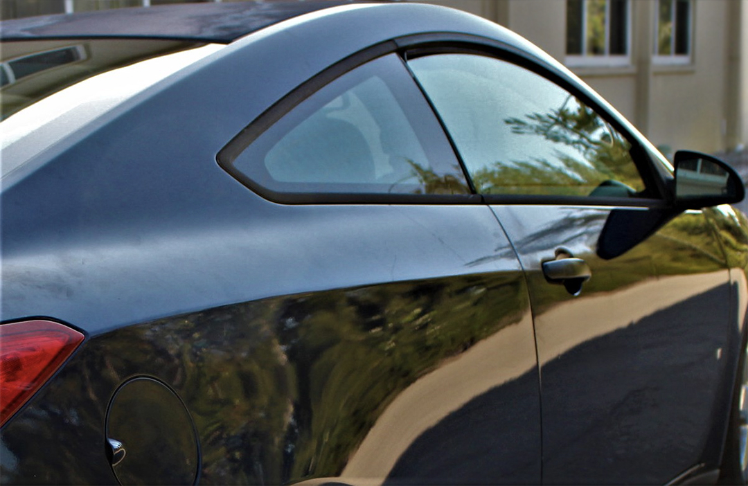 side view of a black vehicle before using the 303 Graphene Nano Spray