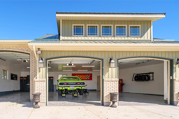 garage building with green Chevy inside