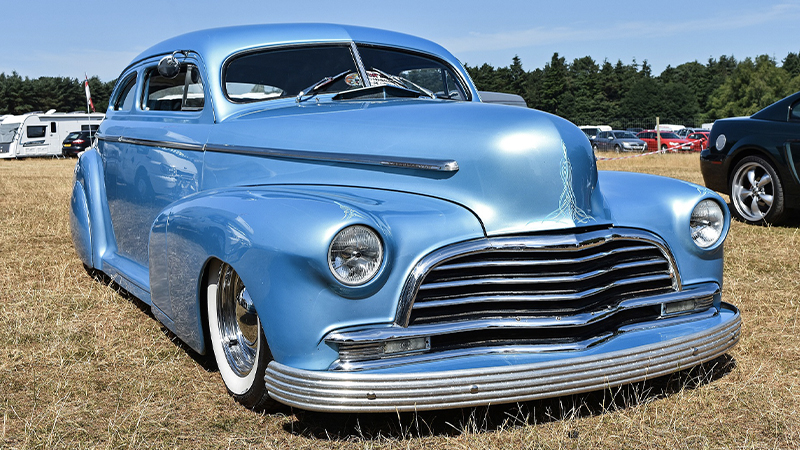 a blue lowrider Mercury at a car show