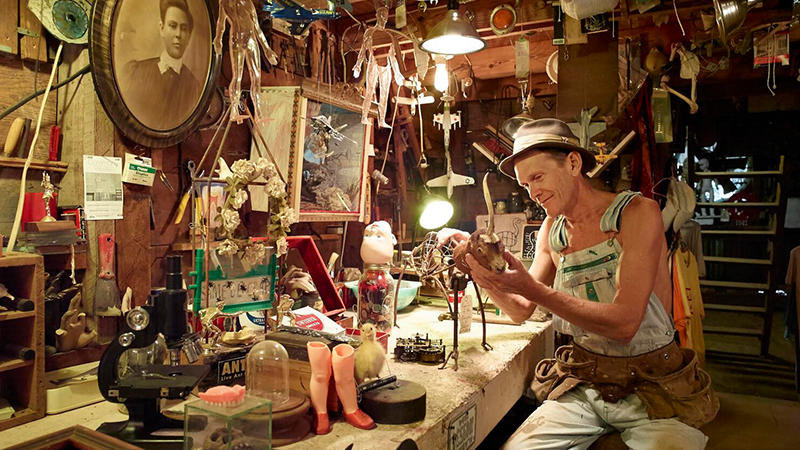Butch Anthony at work in his museum, surrounded by oddities and wonders