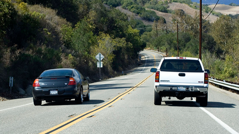 car passing truck on road