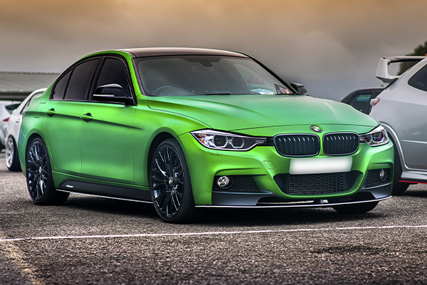wrapped green BMW 3 Series with tinted windows and black wheels | Source: J Morris via Pixabay