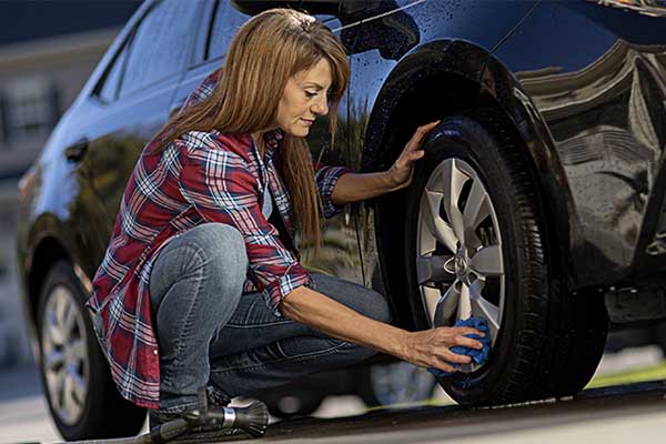 a woman washing a car