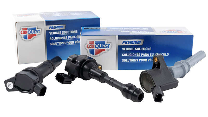 three Carquest Premium ignition coils with packaging in the background