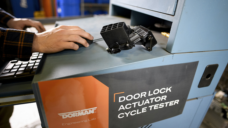 A Dorman door lock actuator at a testing facility