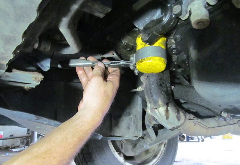Removing oil filter with wrench