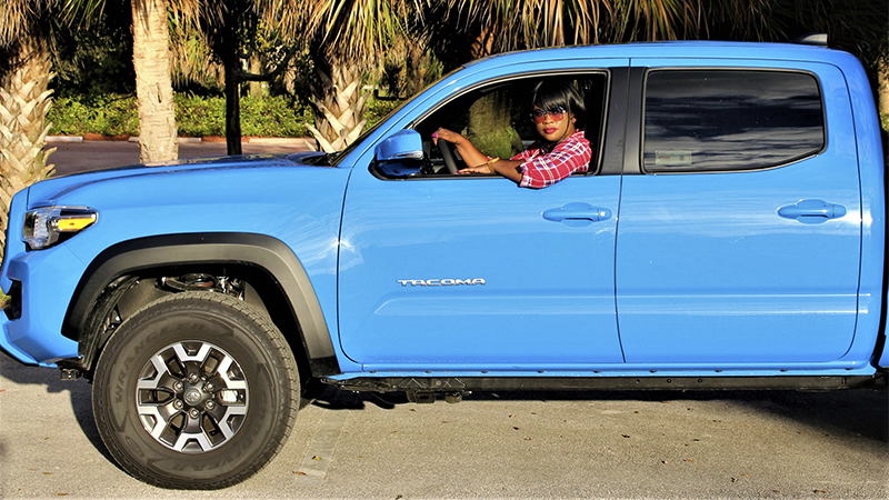 Woman in a blue Toyota Tacoma
