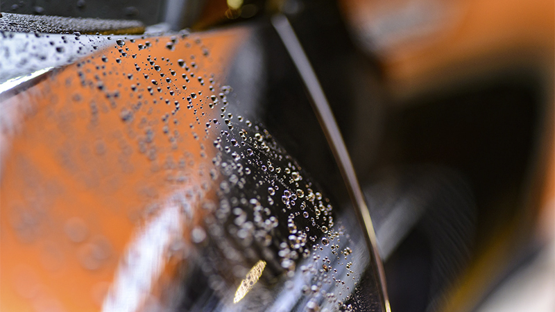 water beading on the surface of a car