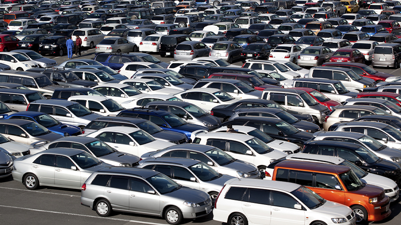 aerial view of a vast car lot packed with different vehicles