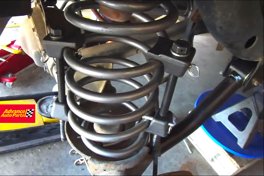 compress rear coil spring