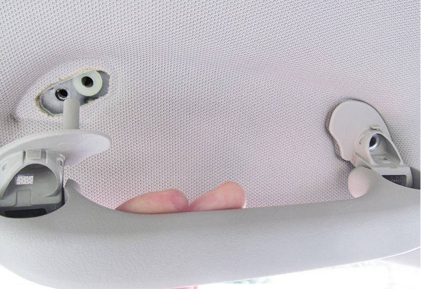 fasteners exposed on overhead handle