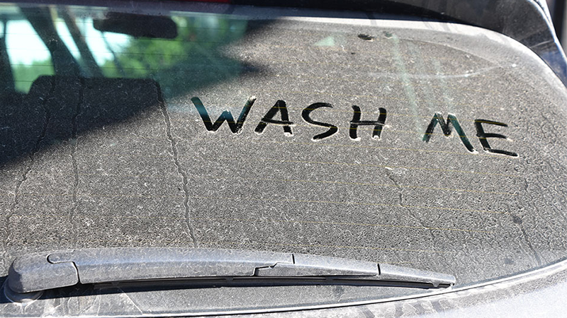 wash me written on vehicle