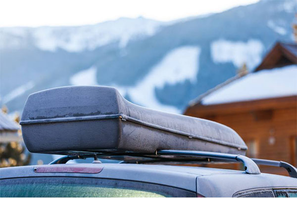 Cargo holder on car with snow-capped mountains in the background