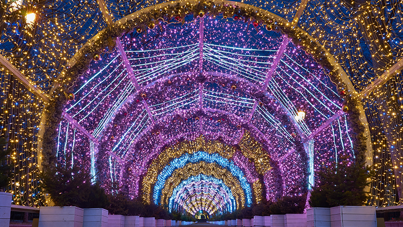 a tunnel of lights with rings of gold, purple and blue