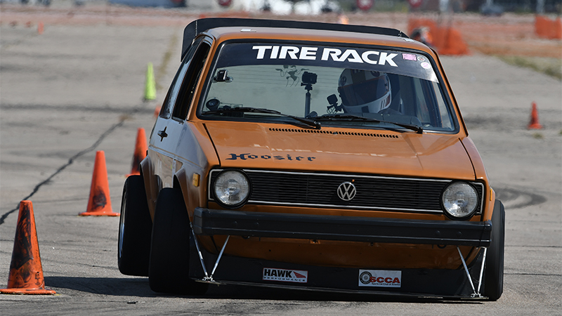 A modified Volkswagen on an autocross course marked by cones