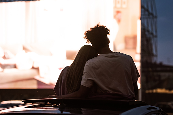 A couple at a drive-in theater.
