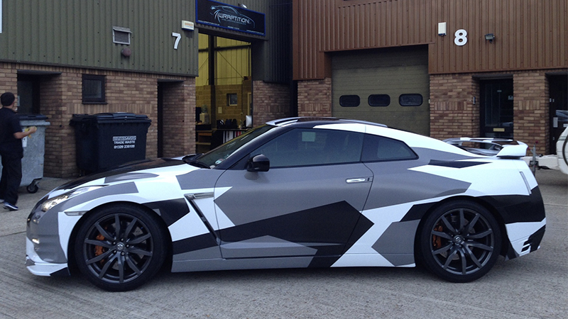 car wrapped in white, black and gray geometric patterns